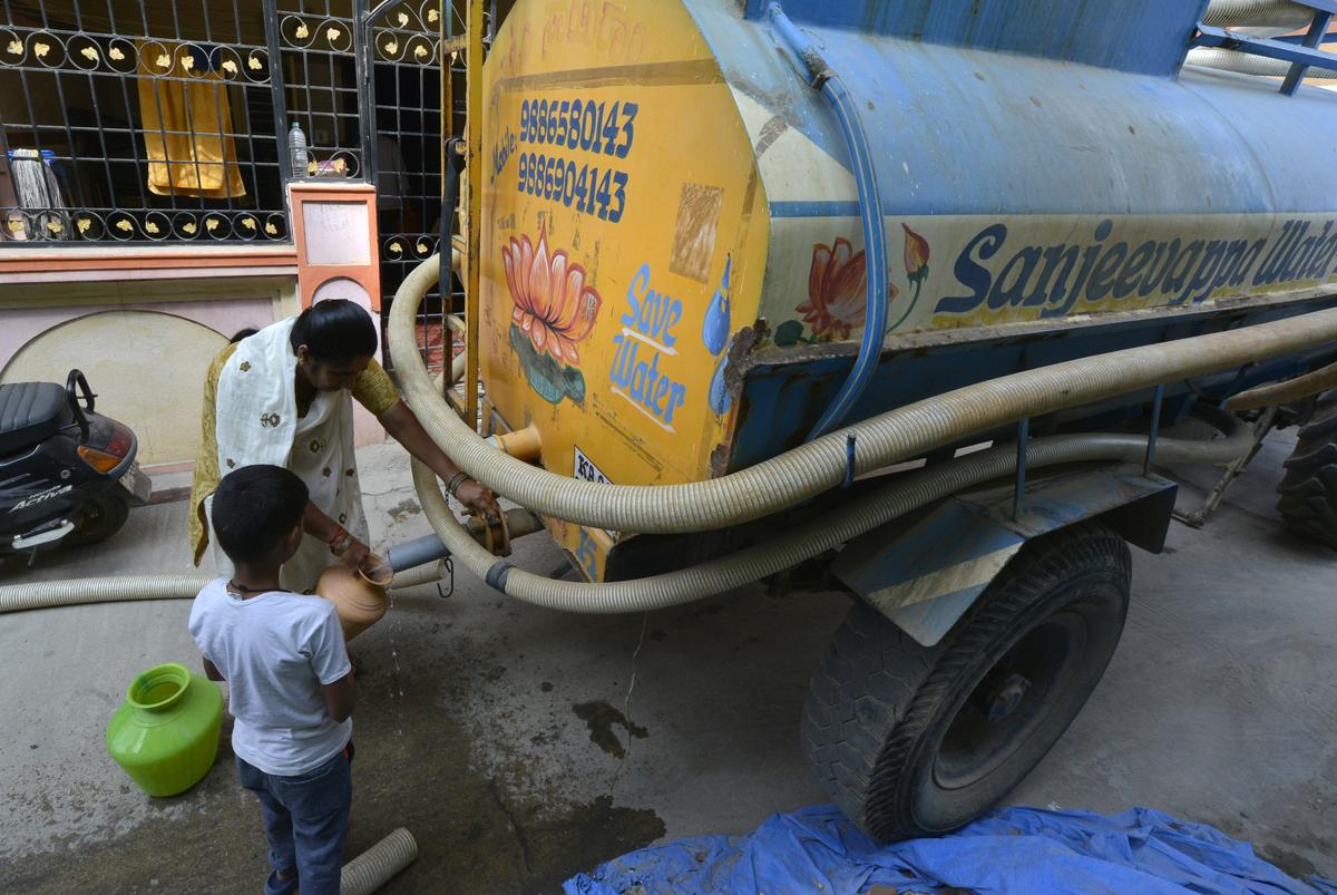 Water being collected from a tanker by residents of Idgah Road in Varthur.