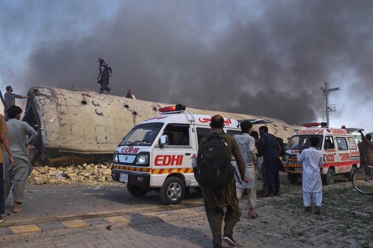Volunteers look for victims from an overturned train coach on a railway track at the site of a bomb explosion in Quetta, Pakistan, on Sunday, May 24, 2026.