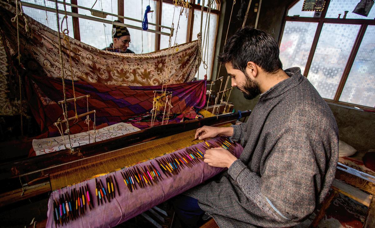     At Kanihama in central Kashmir's Budgam district, Kashmiri craftsmen weave special Kani shawls on handlooms with wooden needles and threads made of pashmina wool.