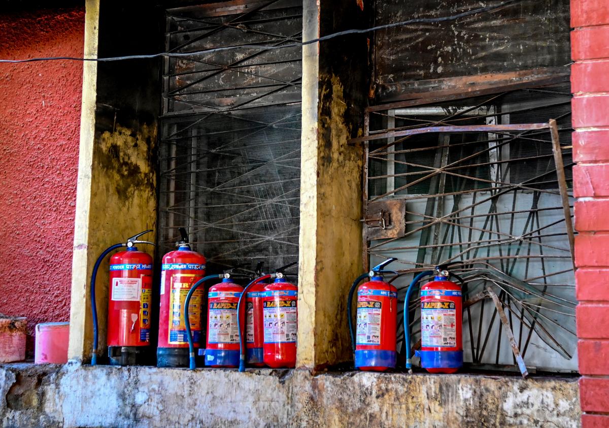 Fire extinguishers, some of them past their expiry dates, are kept outside the neonatal ICU of Maharani Laxmibai Medical College Hospital.