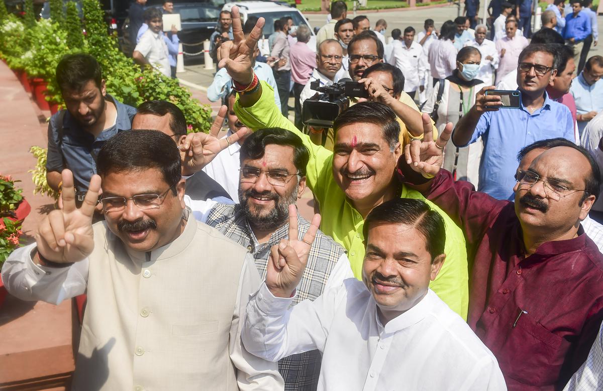 Union Minister Dharmendra Pradhan and other MPs flash victory sign as they arrive to cast votes for the presidential election, on the first day of the Monsoon Session of Parliament, in New Delhi, on Monday, July 18, 2022. 