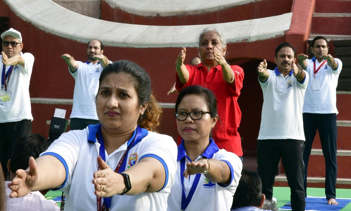 Finance Minister Nirmala Sitharaman performs yoga during the International Yoga Day at the historic Jantar Mantar in New Delhi on Tuesday, June 21, 2022. 
