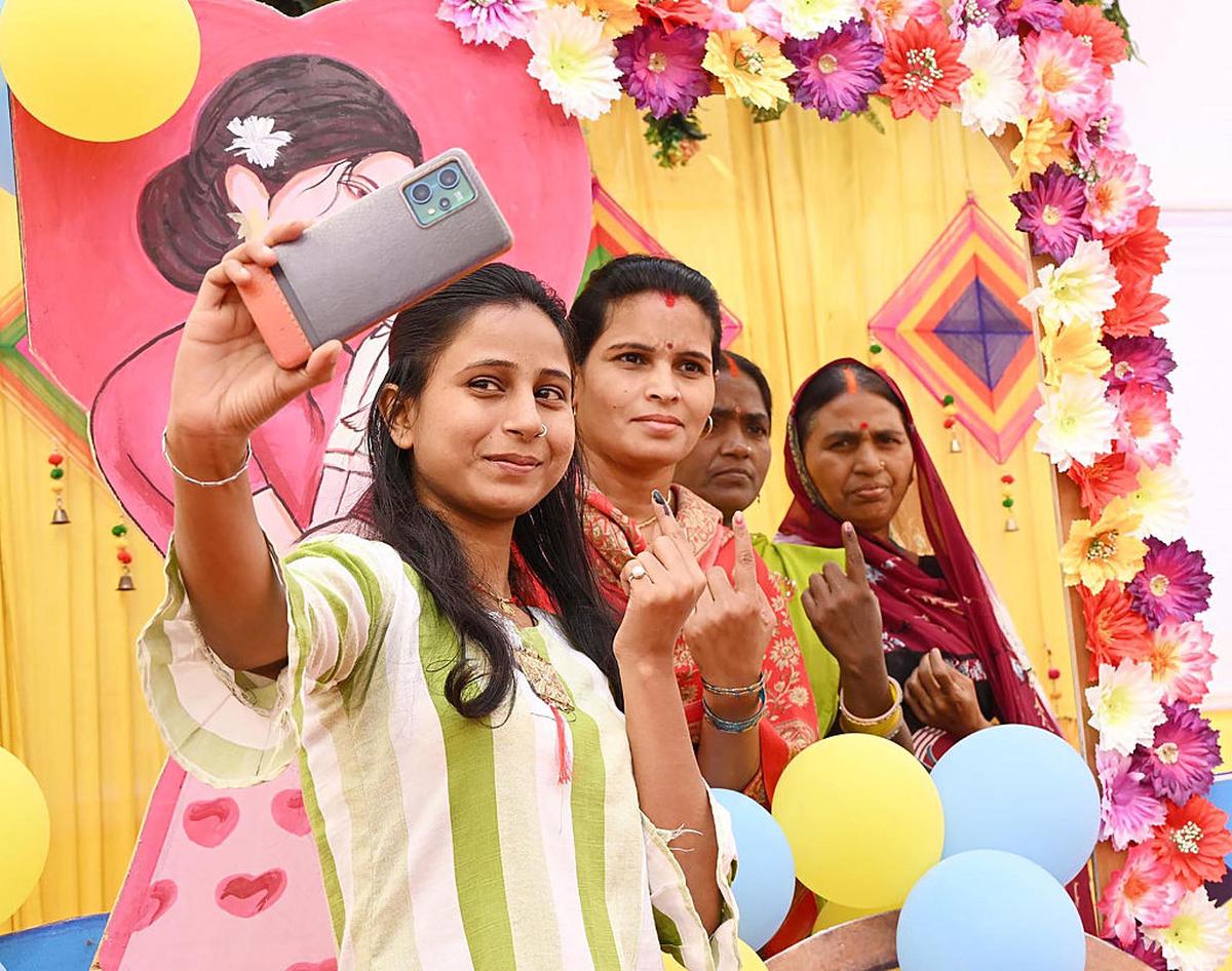 Women taking selfies after casting their votes during the Bihar Assembly Elections in November 2025.