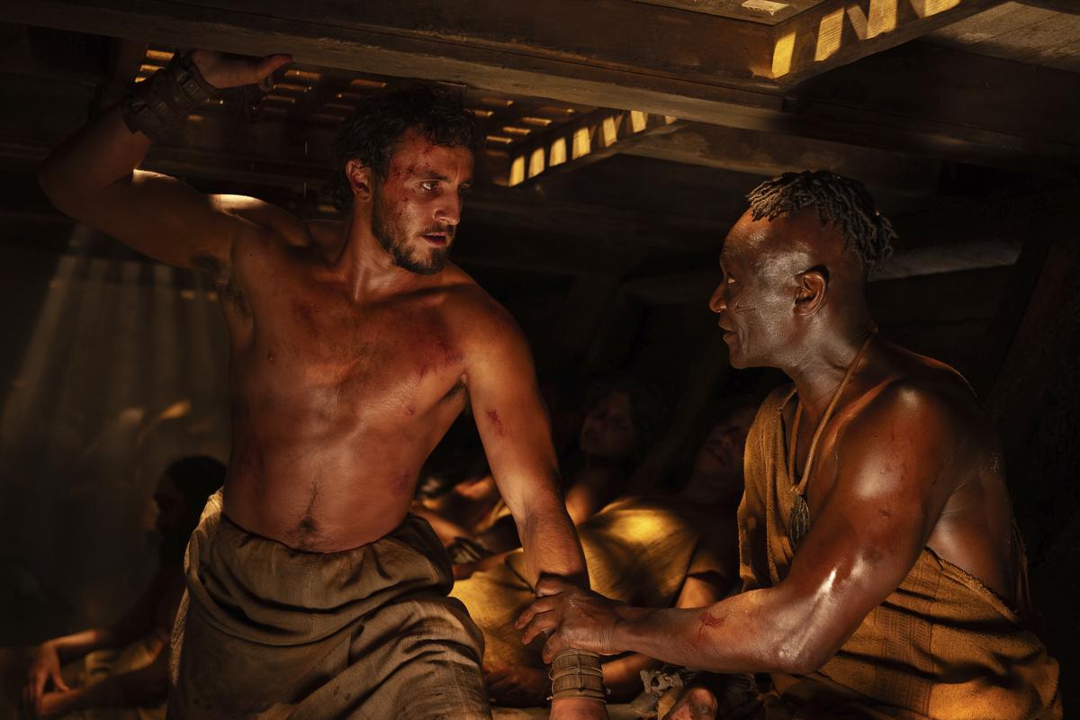 This image released by Paramount Pictures shows Paul Mescal, left, and Peter Mensah in a scene from ‘Gladiator II’