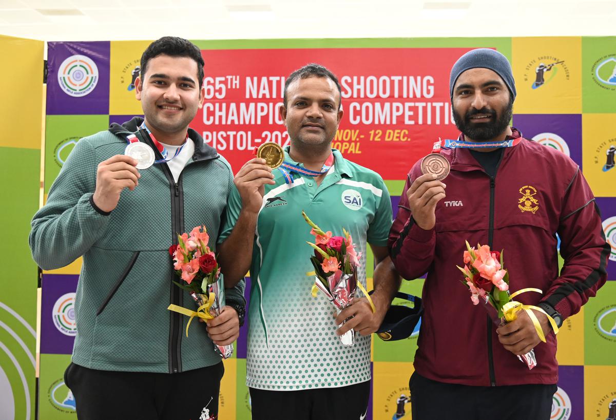 Vijay Kumar (gold), Anish (silver) and Gurpreet Singh (bronze) in the 65th National shooting championship competition in the 25M centre fire pistol men’s event in Bhopal on Monday, December 12, 2022.