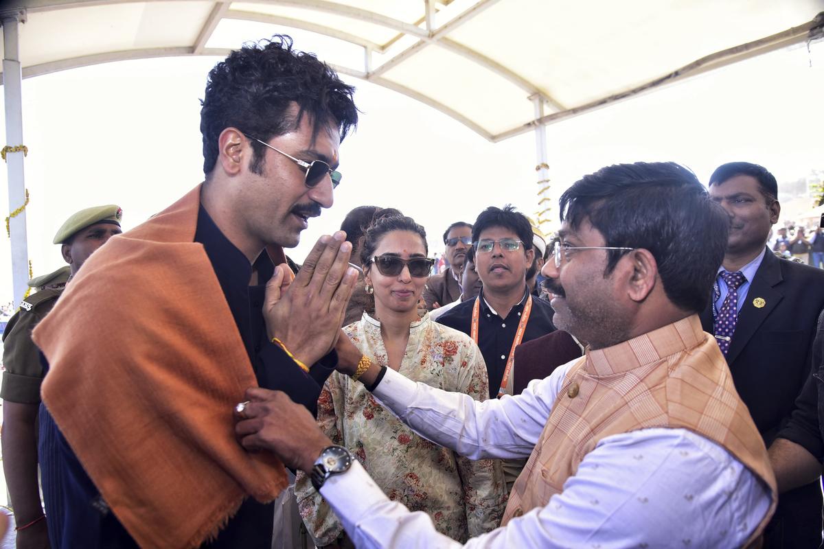 Prayagraj: Bollywood actor Vicky Kaushal being welcomed by UP Cabinet Minister Nand Gopal Gupta Nandi at Sangam during Maha Kumbh festival, in Prayagraj, Thursday, Feb. 13, 2025.