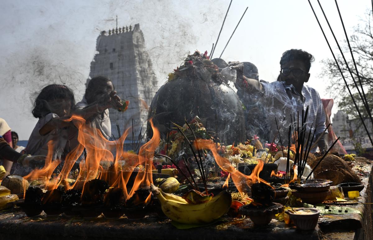 Devotees offer prayers on the occasion of Maha Shivratri at the Sri Rama Lingeshwara Swamy temple of Keesaragutta, Medchal-Malkajgiri district, on Wednesday. 