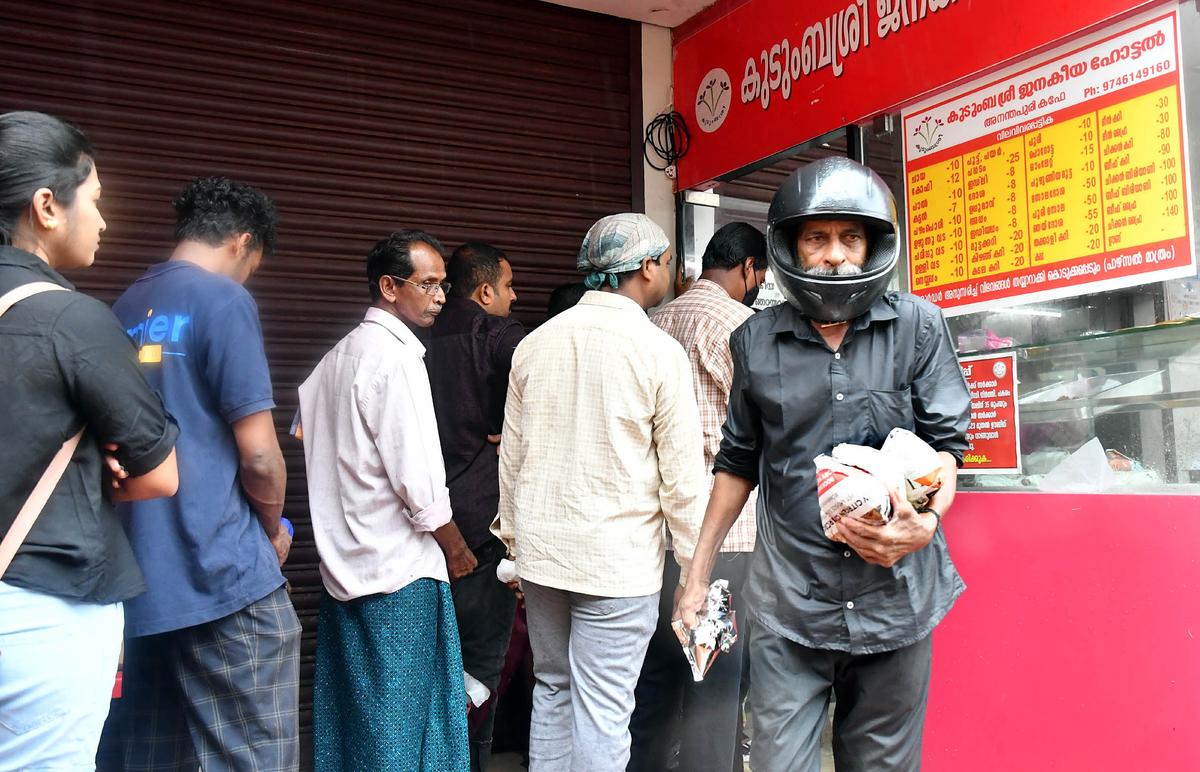 People que up to buy meals at a Kudumbashree Janakeeya Hotel in Thiruvananthapuram.