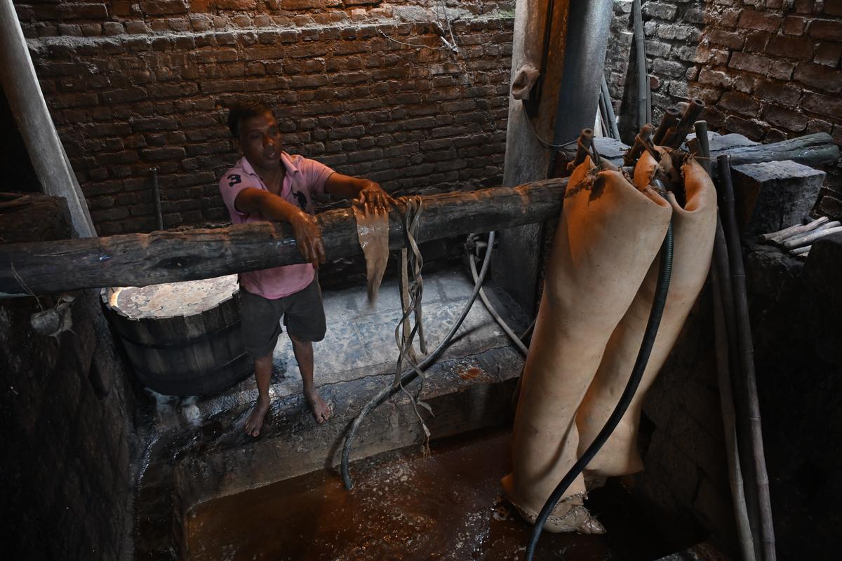 Shantaram Sonawane colour dyeing the leather used in Kolhapuri Chappals at Ichalkaranji on Thursday.