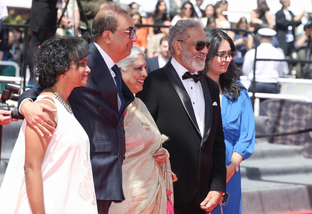 Indian filmmaker and producer Shivendra Singh Dungarpur (2L), Indian film editor Bina Paul (C) and Indian actor Joy Mathew (2R) pose as they arrive for the screening of the film 'Amma Ariyan'