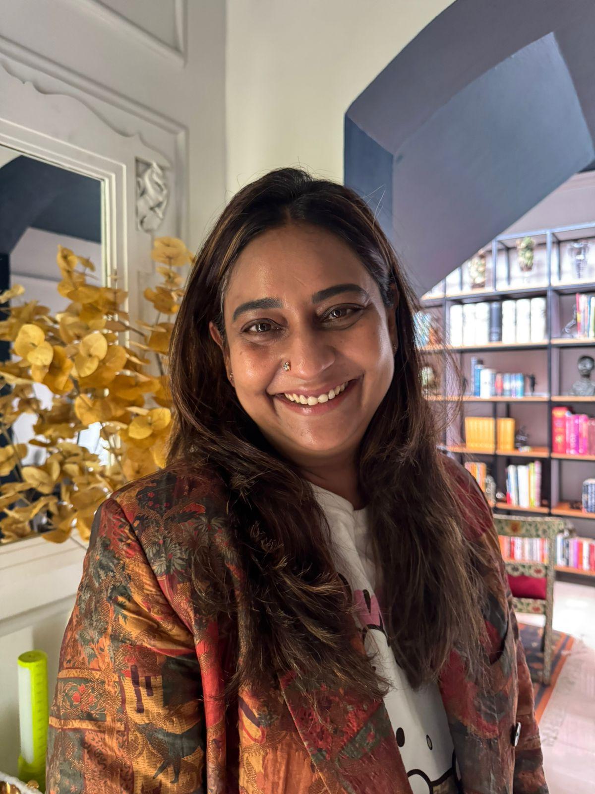 Arti Muthiah and the XXXL bookcase in the background. Arti Muthiah and the XXXL bookcase in the background.