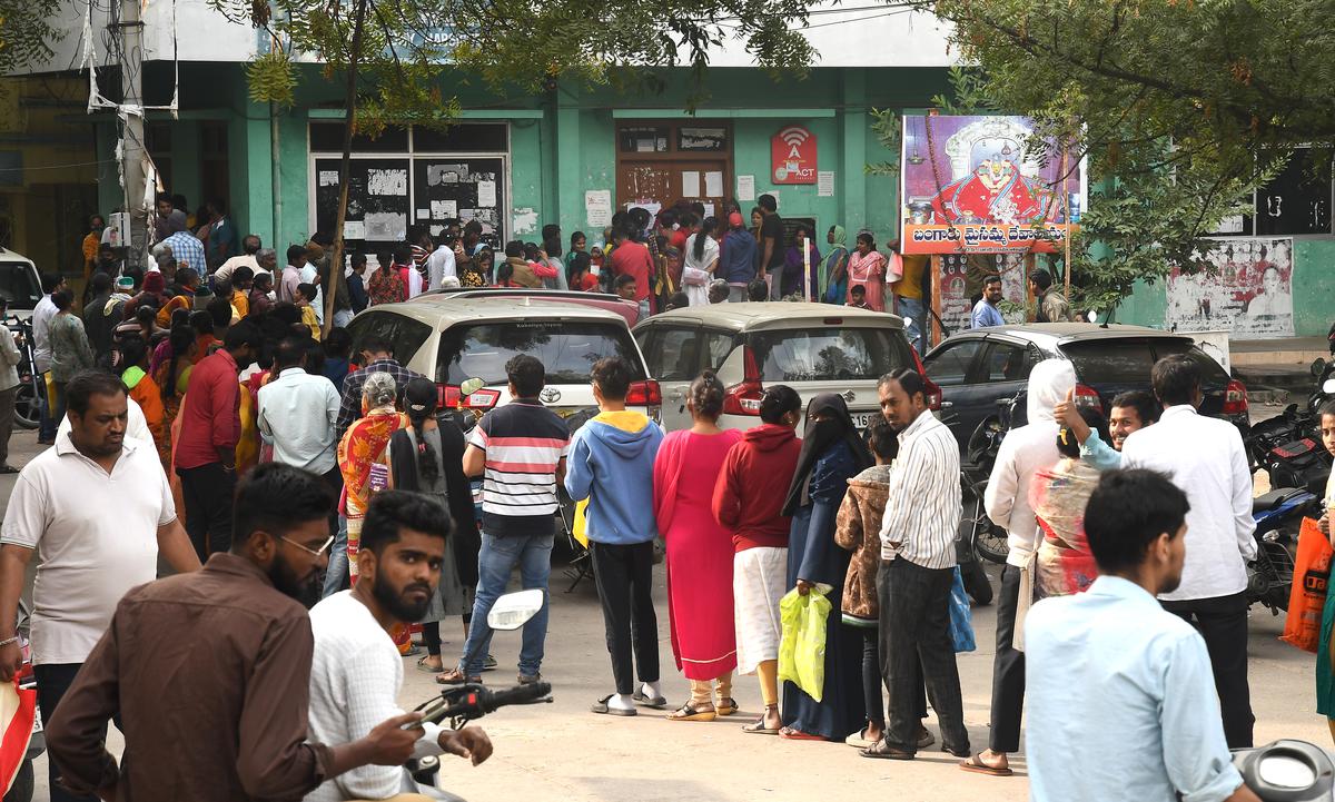 People wait to submit their Abhaya Hastham application forms in Hyderabad on December 29, 2023.
