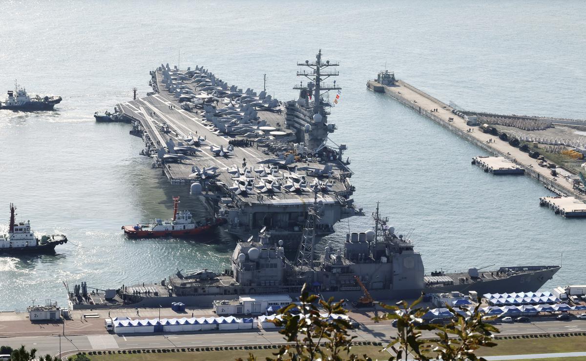 U.S. nuclear-powered aircraft carrier USS Ronald Reagan is escorted as it arrives in Busan, South Korea, Thursday, Oct. 12, 2023.