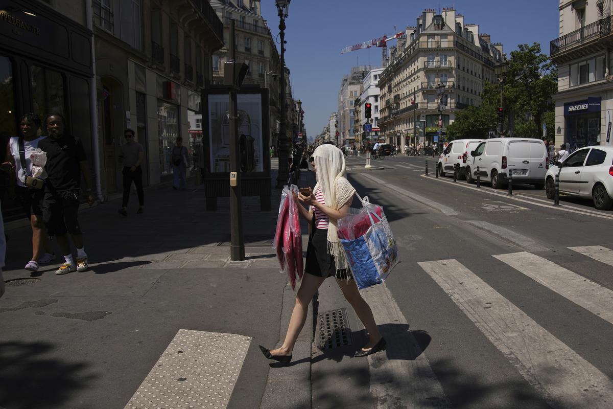 A woman protects her head during a heat wave A woman protects her head during a heat wave