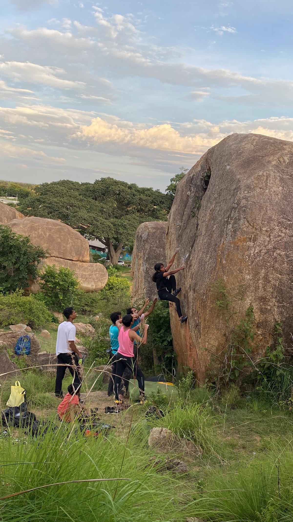 Climbers attempting bouldering outdoors
