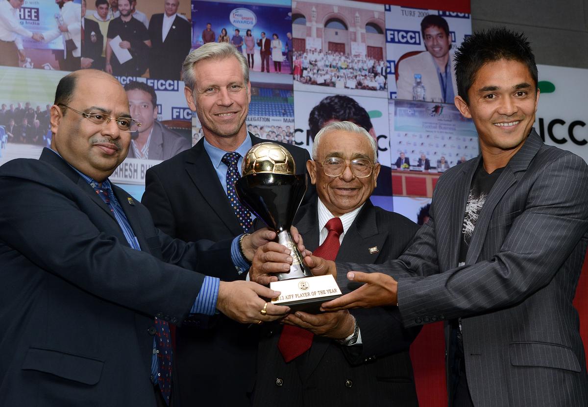 Chhetri receives the Best Footballer of the Year Award from A.R. Khaleel, Subrata Dutta and Wim Koeverman during AIFF award function, in New Delhi on February 12, 2014.