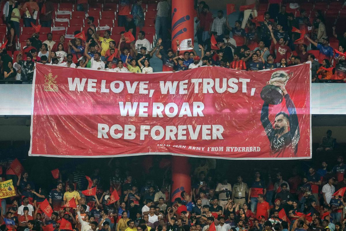 Royal Challengers Bengaluru's fans carrying a large banner cheer from the stands during the 2026 Indian Premier League (IPL) T20 match between Royal Challengers Bengaluru and Chennai Super Kings at the M Chinnaswamy Stadium in Bengaluru on April 5, 2026. Royal Challengers Bengaluru's fans carrying a large banner cheer from the stands during the 2026 Indian Premier League (IPL) T20 match between Royal Challengers Bengaluru and Chennai Super Kings at the M Chinnaswamy Stadium in Bengaluru on April 5, 2026.