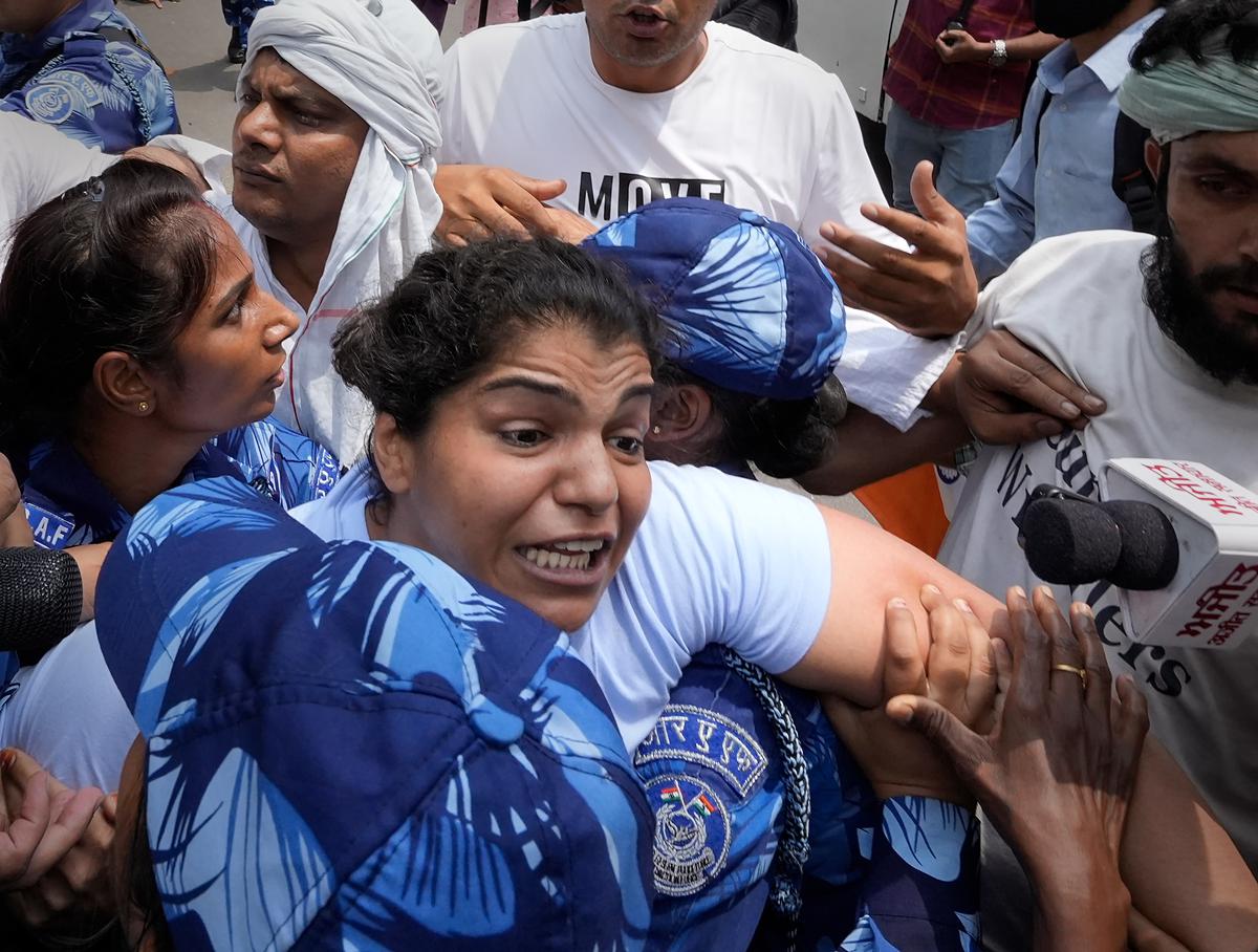 Security personnel detain wrestler Sakshi Malik during wrestlers’ protest march towards new Parliament building in New Delhi on May 28, 2023.