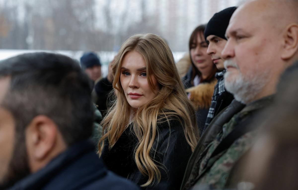Miroslava Reginskaya, wife of Russian prominent nationalist, former military commander and Kremlin critic Igor Girkin, who is charged with inciting extremist activity, stands in front of journalists after a hearing outside a court building in Moscow.