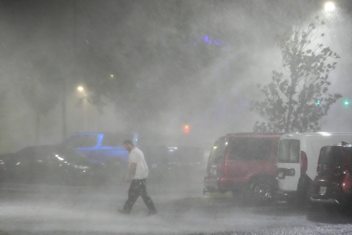 A man walks in the parking lot outside a hotel in Tampa, Florida, U.S., on October 9, 2024