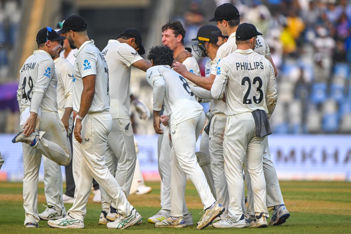 New Zealand players celebrate after Matt Henry runs out Virat Kohli on the first day of the third Test between India and New Zealand at the Wankhede Stadium in Mumbai on November 1, 2024.