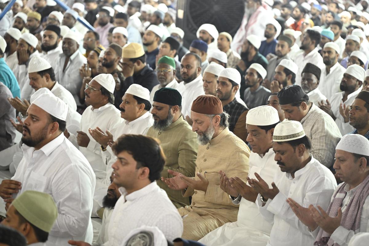 AIMIM president Asaduddin Owaisi and others pray at the Jalsa Youm‑ul‑Quran at Makkah Masjid in Hyderabad on Friday.