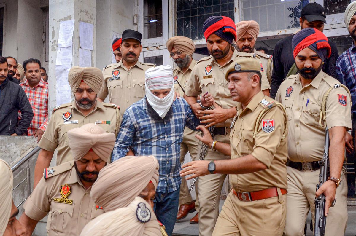 Punjab Police personnel take accused Sandeep Singh, who allegedly shot Shiv Sena (Taksali) leader Sudhir Suri, to a court for questioning in Amritsar, on Nov. 5, 2022. 