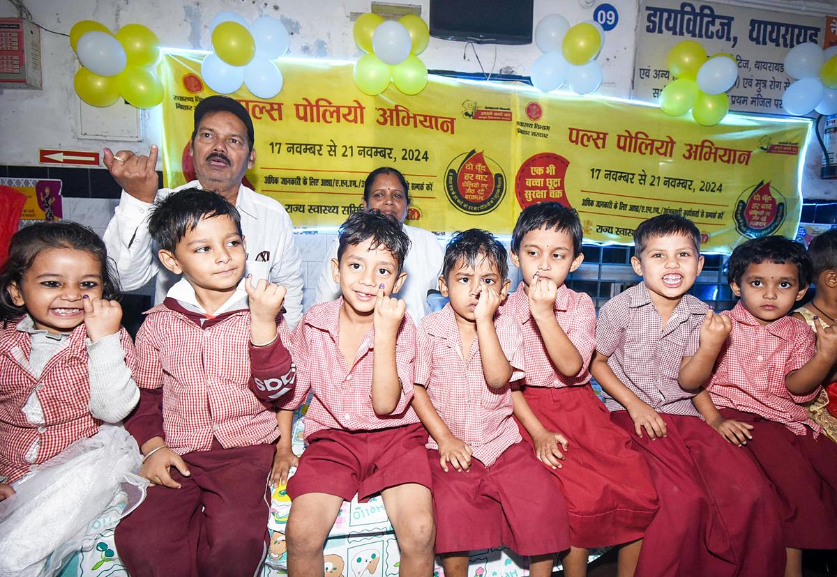 Children show their ink-marked fingers after being administered with polio drops by healthcare workers as part of the Pulse Polio Program, at New Gardiner Road Hospital in New Delhi.