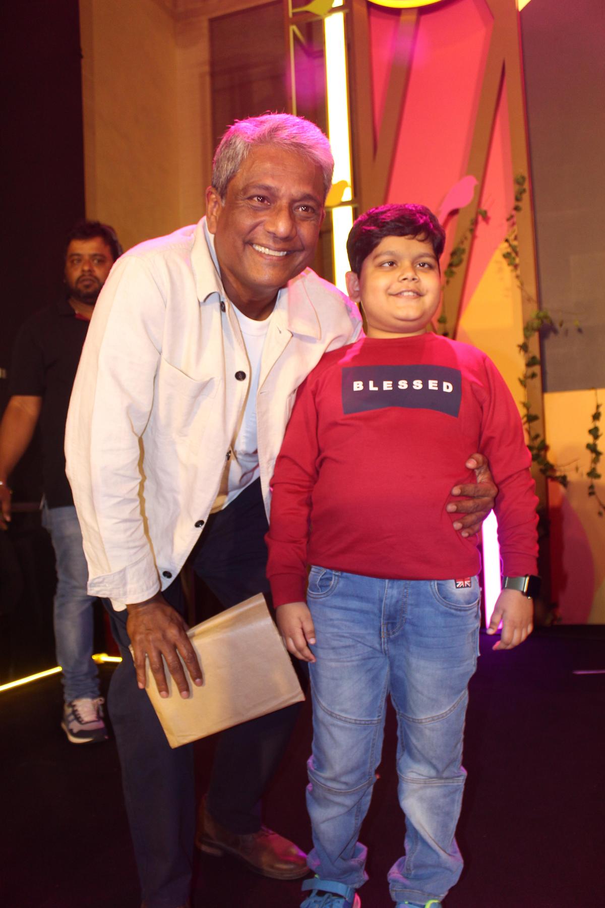Actor Adil Hussain with Prathamesh Sinha, a 12-year-old with blindness, who emceed at IIS 2023