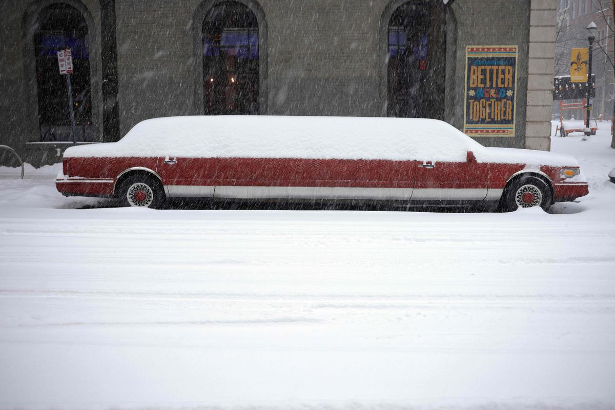 A snow-covered stretch limousine sits parked on January 5, 2025 in downtown Louisville, Kentucky. Local forecasts called for heavy snowfall followed by significant accumulation of freezing rain and ice.  