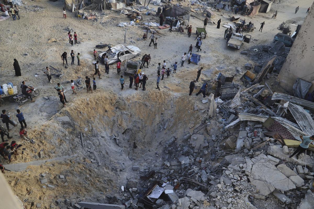 Palestinians inspect the site struck by an Israeli bombardment in Muwasi, Khan Younis, Gaza Strip, Monday, July 28, 2025. Palestinians inspect the site struck by an Israeli bombardment in Muwasi, Khan Younis, Gaza Strip, Monday, July 28, 2025.