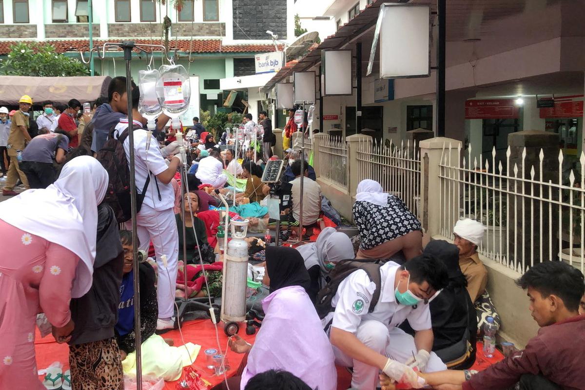 Medical workers treat the victims outside a hospital building after an earthquake hit in Cianjur, West Java province, Indonesia, on November 21, 2022.