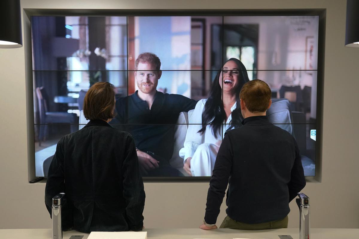 Office workers in London, watch the Duke and Duchess of Sussex’s controversial documentary being aired on Netflix
