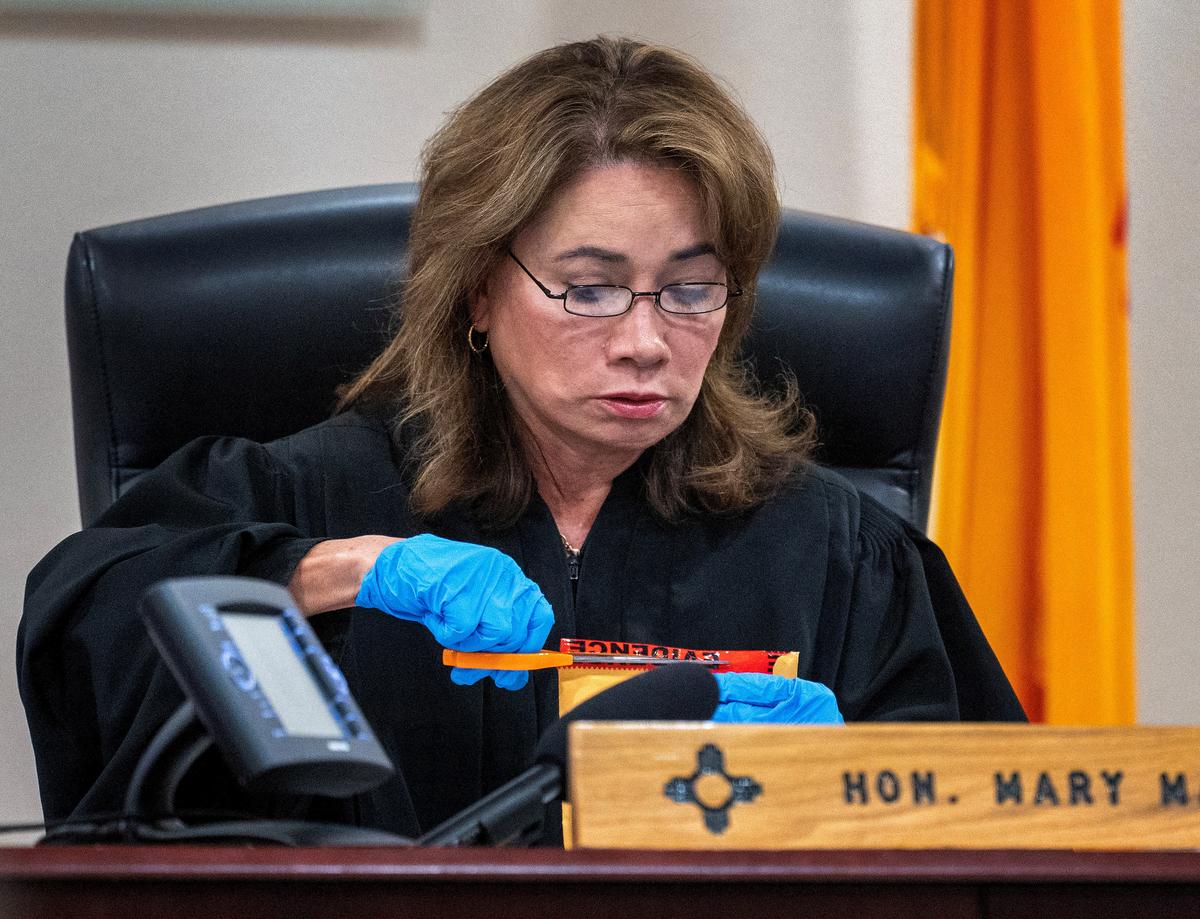 Judge Mary Marlowe Sommer opens a package of evidence not turned over to defence attorneys in the trial against Alec Baldwin, in Santa Fe, N.M. Friday, July 12, 2024. 