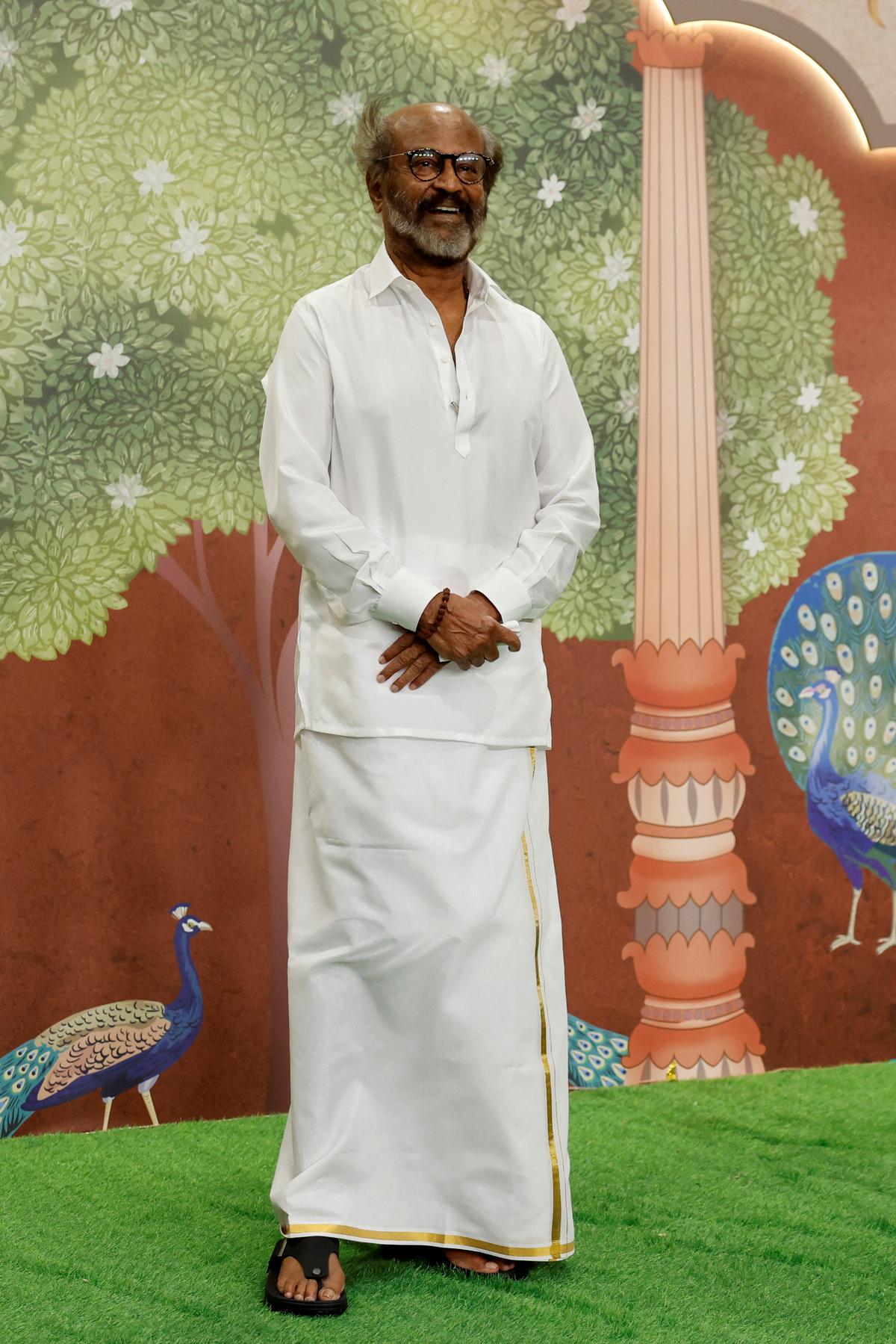 Indian Actor Rajinikanth poses for pictures on the red carpet while attending the blessing ceremony of Anant Ambani and Radhika Merchant after their wedding on July 13, 2024 in Mumbai, India.