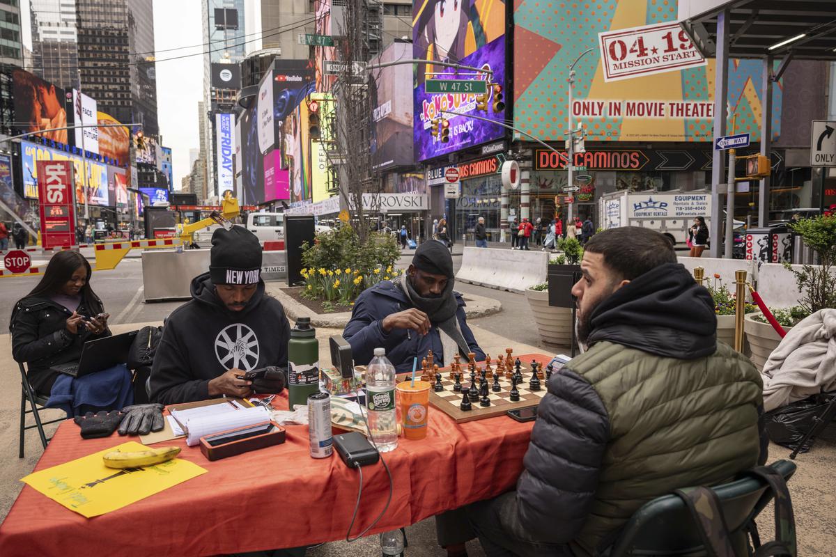 Tunde Onakoya (center) Nigerian chess champion and child education advocate, plays a chess game in Times Square, in New York on April 19, 2024. Tunde Onakoya (center) Nigerian chess champion and child education advocate, plays a chess game in Times Square, in New York on April 19, 2024.