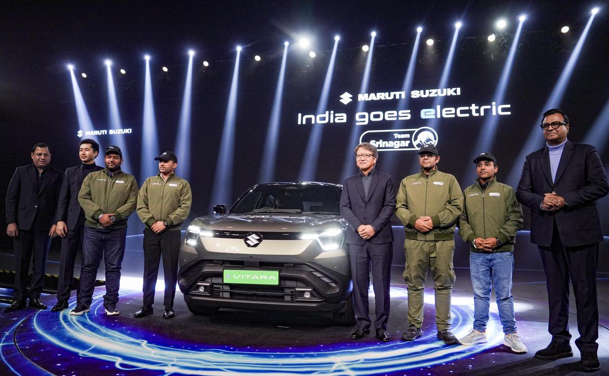 Maruti Suzuki India MD and CEO Hisashi Takeuchi, company's Senior Executive Officer Marketing and Sales Partho Banerjee and others with the newly-introduced first electric vehicle model 'e Vitara', in Gurugram, Tuesday, December 2, 2025.  