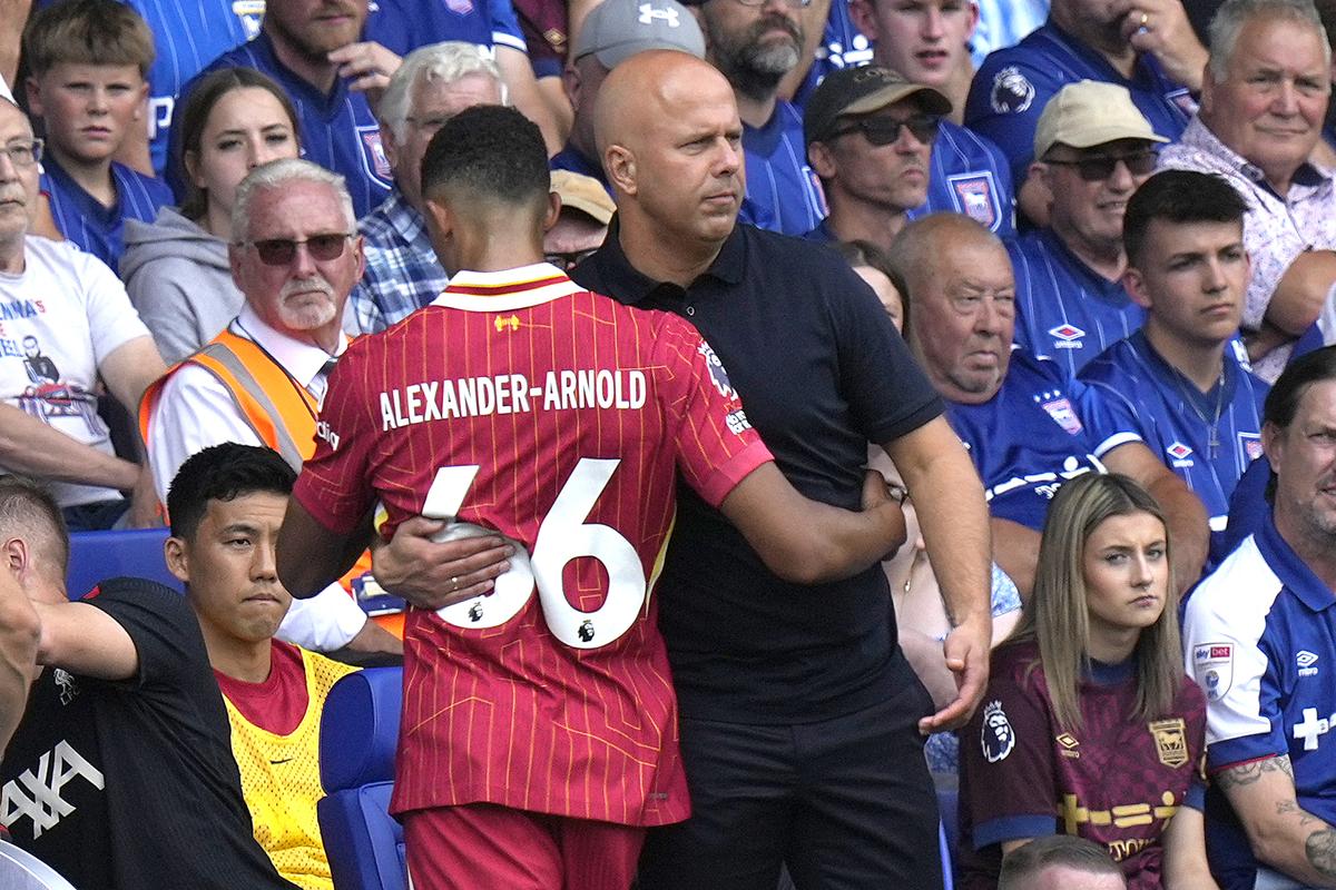 Liverpool’s manager Arne Slot hugs Liverpool’s Trent Alexander-Arnold as he is substituted 