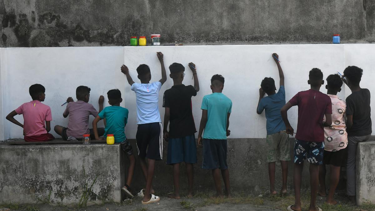 Tribal children showcase a mural painting at ‘Sea: A Boiling Vessel’ by Aazhi Archives in Kochi