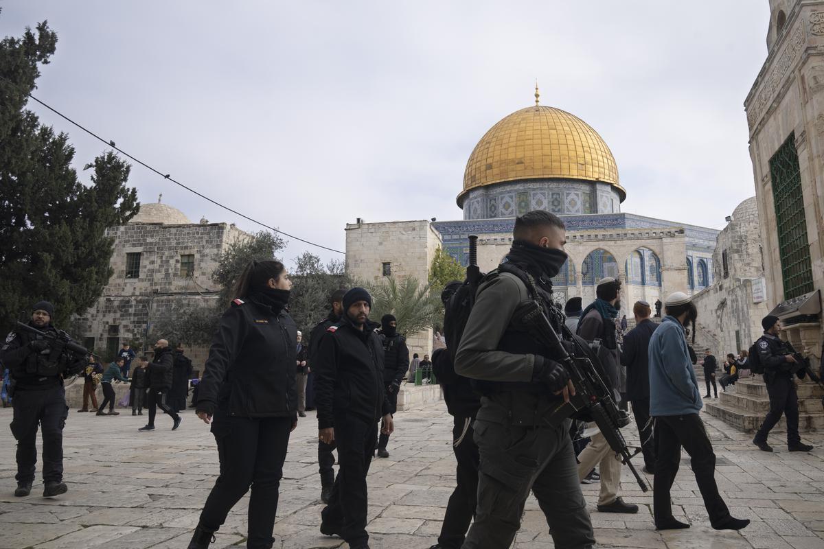 Israeli police escort Jewish visitors to the Al-Aqsa Mosque compound, known to Muslims as the Noble Sanctuary and to Jews as the Temple Mount, in the Old City of Jerusalem, on Jan. 3, 2023.  