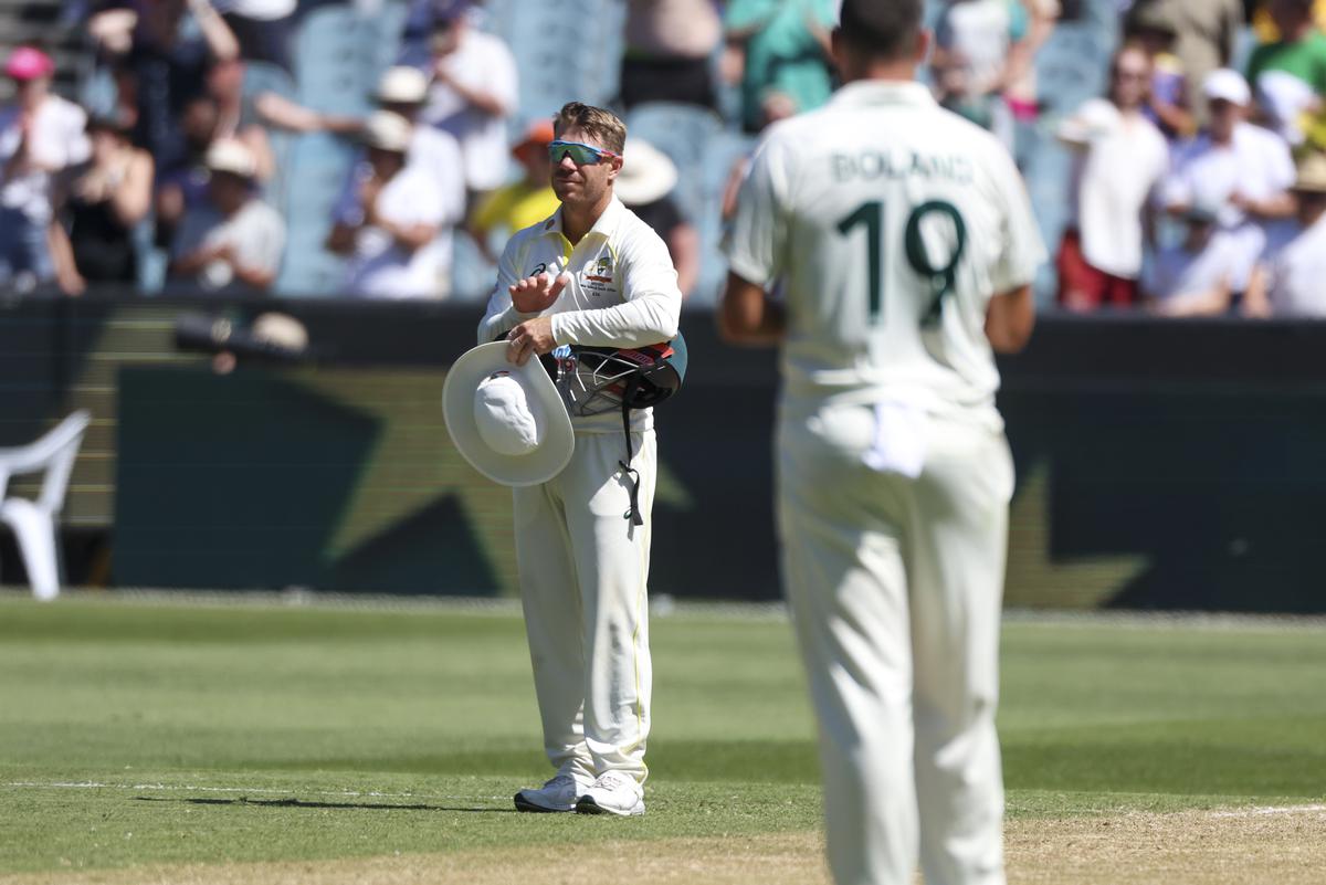 Australia’s David Warner pauses during play for a tribute for former Australian cricket star Shane Warne who passed away earlier in the year, during the second cricket test between South Africa and Australia at the Melbourne Cricket Ground, Australia, Monday, Dec. 26, 2022.