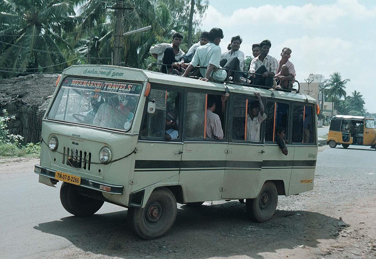 To commute to their destination during the strike by transport employees, passengers travel on the roof of a crowded van at Old Mahabalipuram Road near Chennai on November 12, 2001