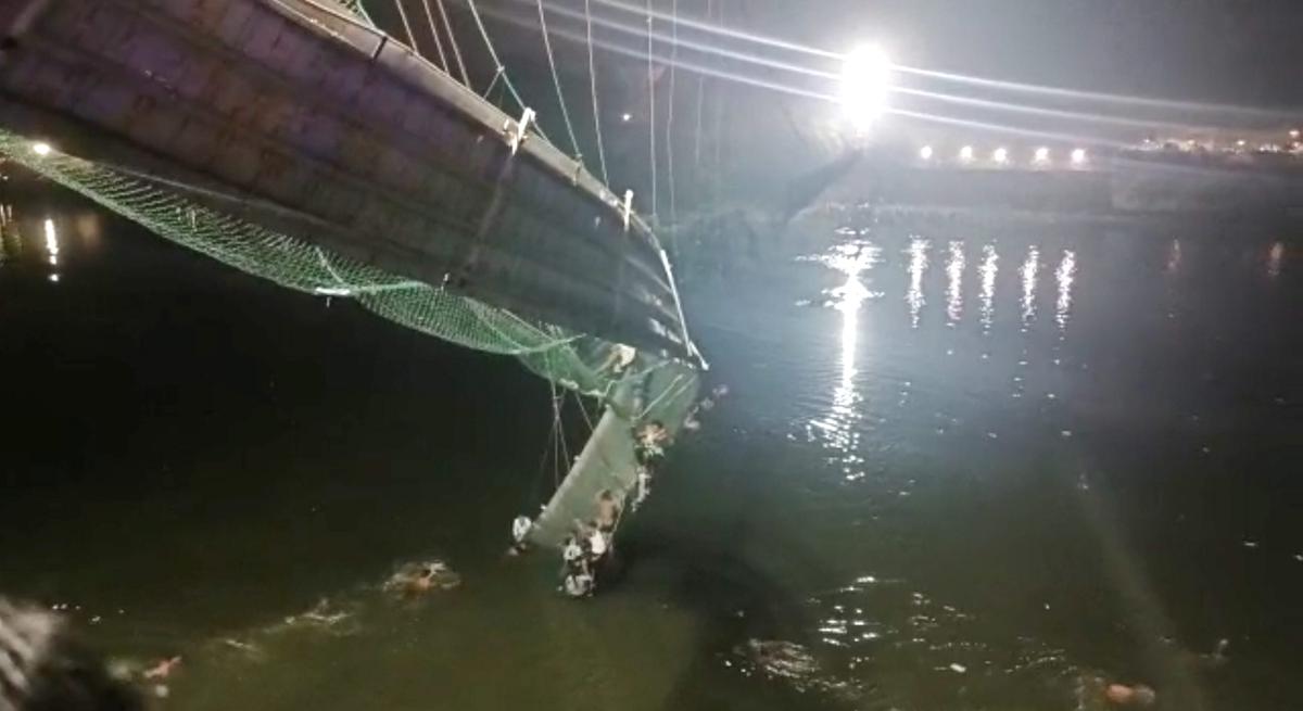  Rescue operation under way after an old suspension bridge over the Machchhu river collapsed, in Morbi district on October 30, 2022.