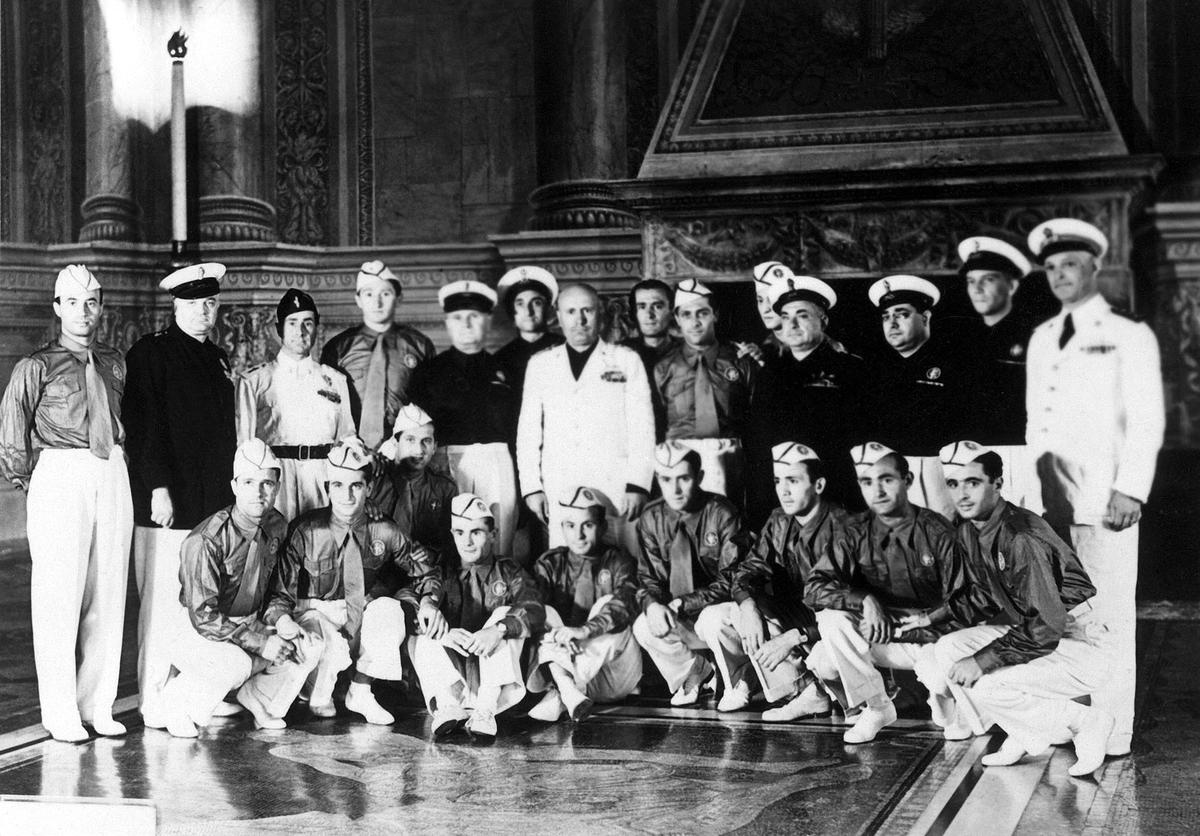 Benito Mussolini (centre, in white) poses with the Italian national soccer team during a reception at the Palazzo Venezia in Rome in 1938. Italy, winner of the 1934 World Cup, retained its title, with a 4-2 victory over Hungary.