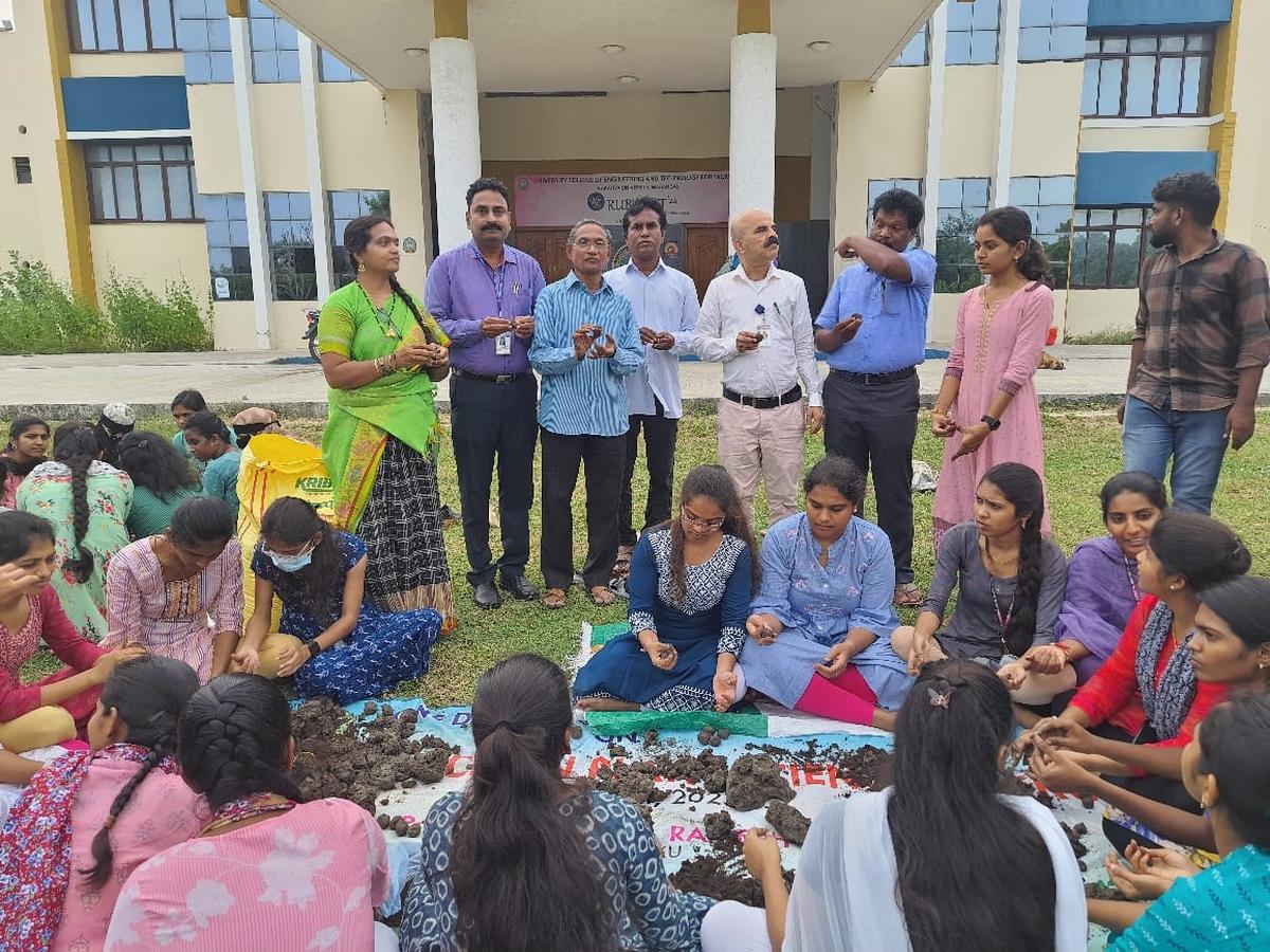 KU Registrar Prof. P Malla Reddy, NSS programme officials inspect the seedball preparation programme.