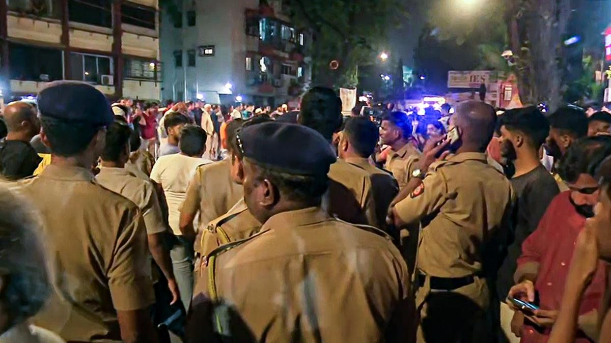 A crowd gathers outside Lilavati Hospital where senior NCP leader Baba Siddique was admitted after he was shot by unidentified gunmen in Mumbai on October 12, 2024.