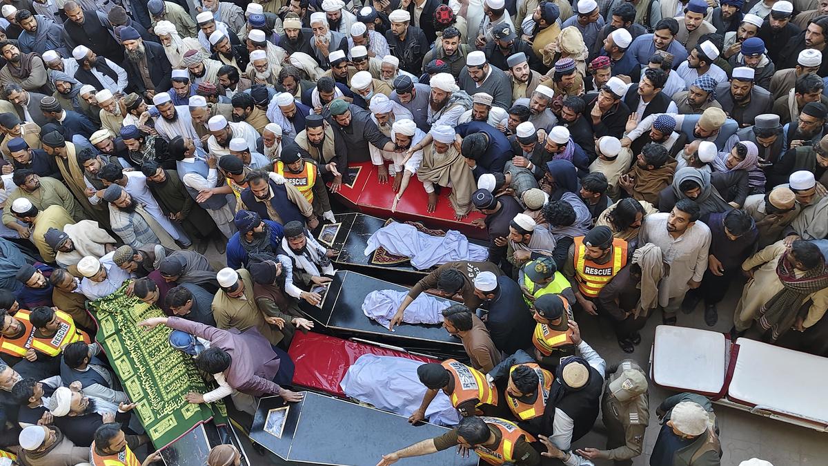 Pakistanis mourn 18 people, including 5 soldiers, killed in a twin suicide bombing at an army base