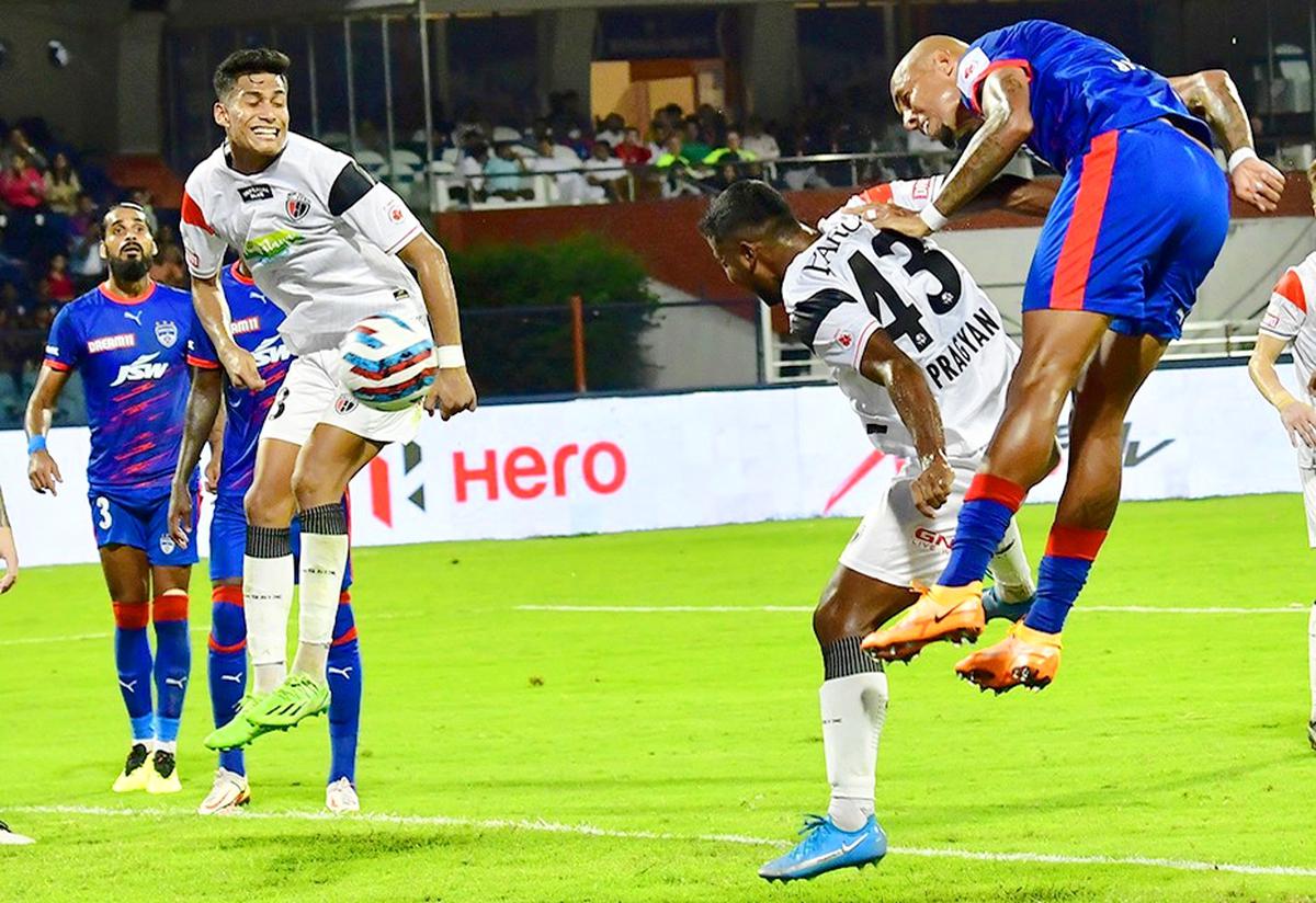 Alan Costa, right, heads the ball to score a goal during the Indian Super League (ISL) match between Bengaluru FC and NorthEast United FC, at the Sree Kanteerava stadium, in Bengaluru on October 8, 2022. 