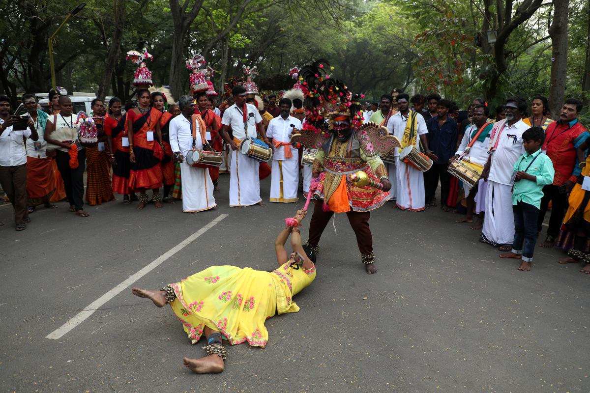 Telkooth artistes dance during a procession at the 11th folk festival 'Veethi Virudu Visa' at Loyola College, Nungambakkam, Chennai on Thursday. 