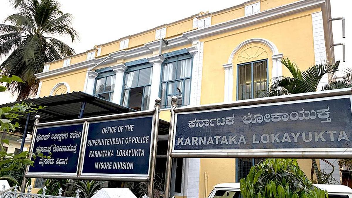 Congress workers gather outside Lokayukta police office in Mysuru with ‘Satyameva Jayate’ placards